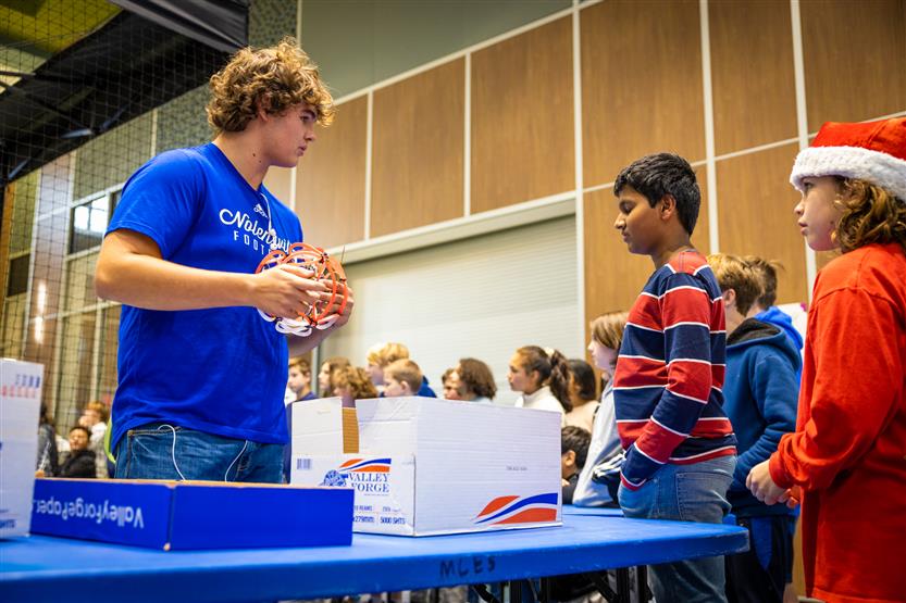 Middle and high school students learning about drone soccer